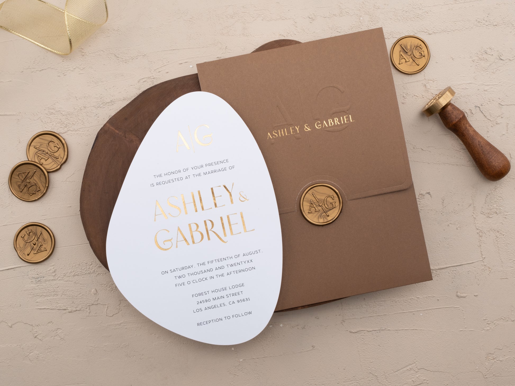 Brown and gold wedding invitation suite with oval foil-printed invite and monogrammed envelope