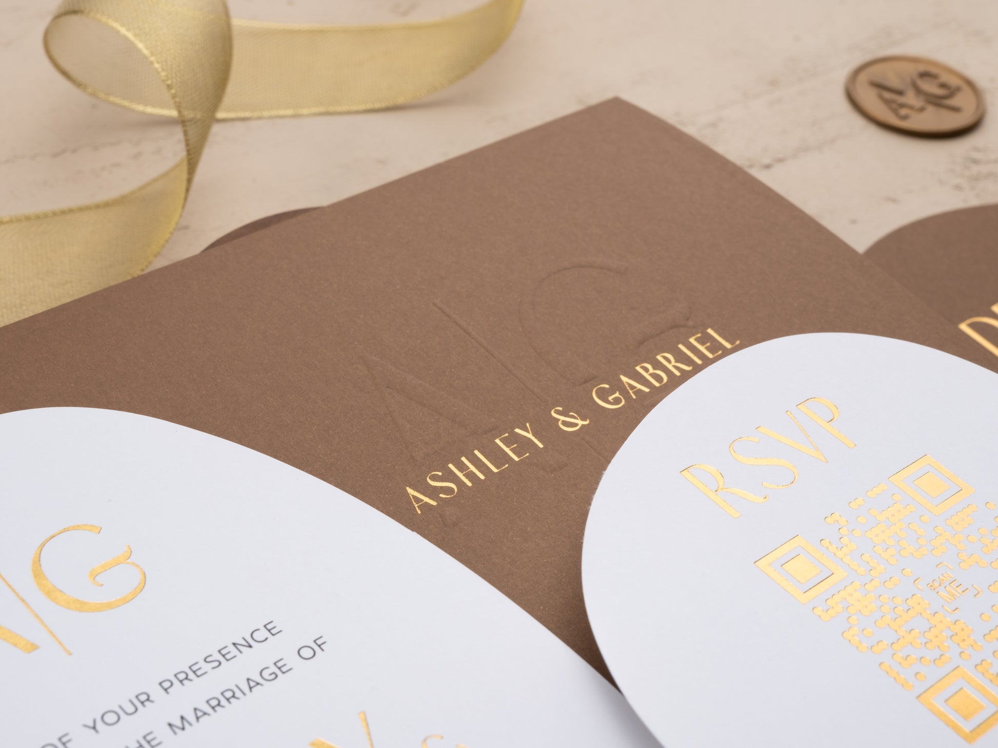 Close-up of gold foil RSVP card and embossed envelope