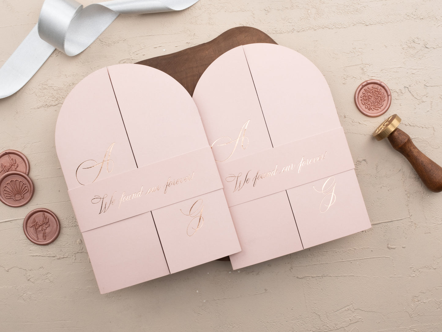 Blush pink arch folded acrylic wedding invitation with Belly Band (says "We Found our forever!")