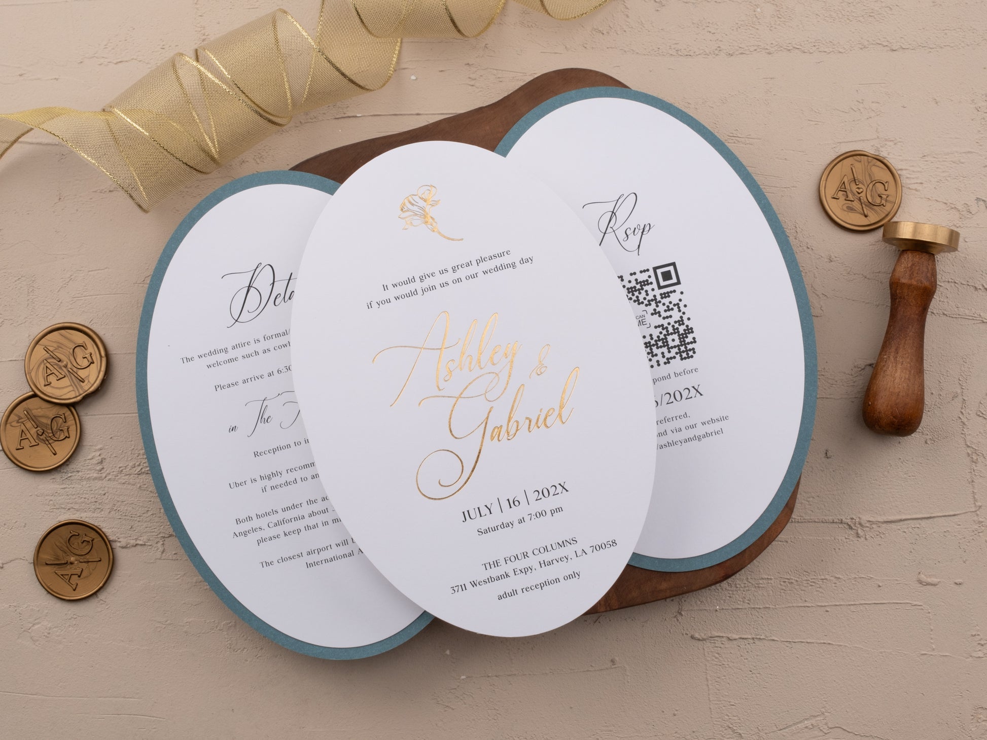 Gold foil wedding invitation next to floral embossed dusty blue jacket