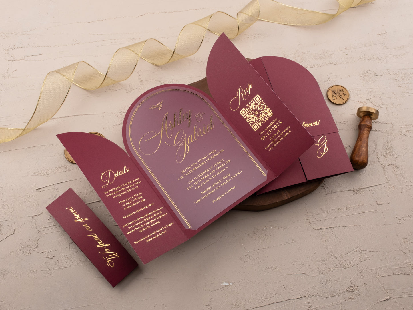 Gold foil RSVP and details card inside burgundy invitation