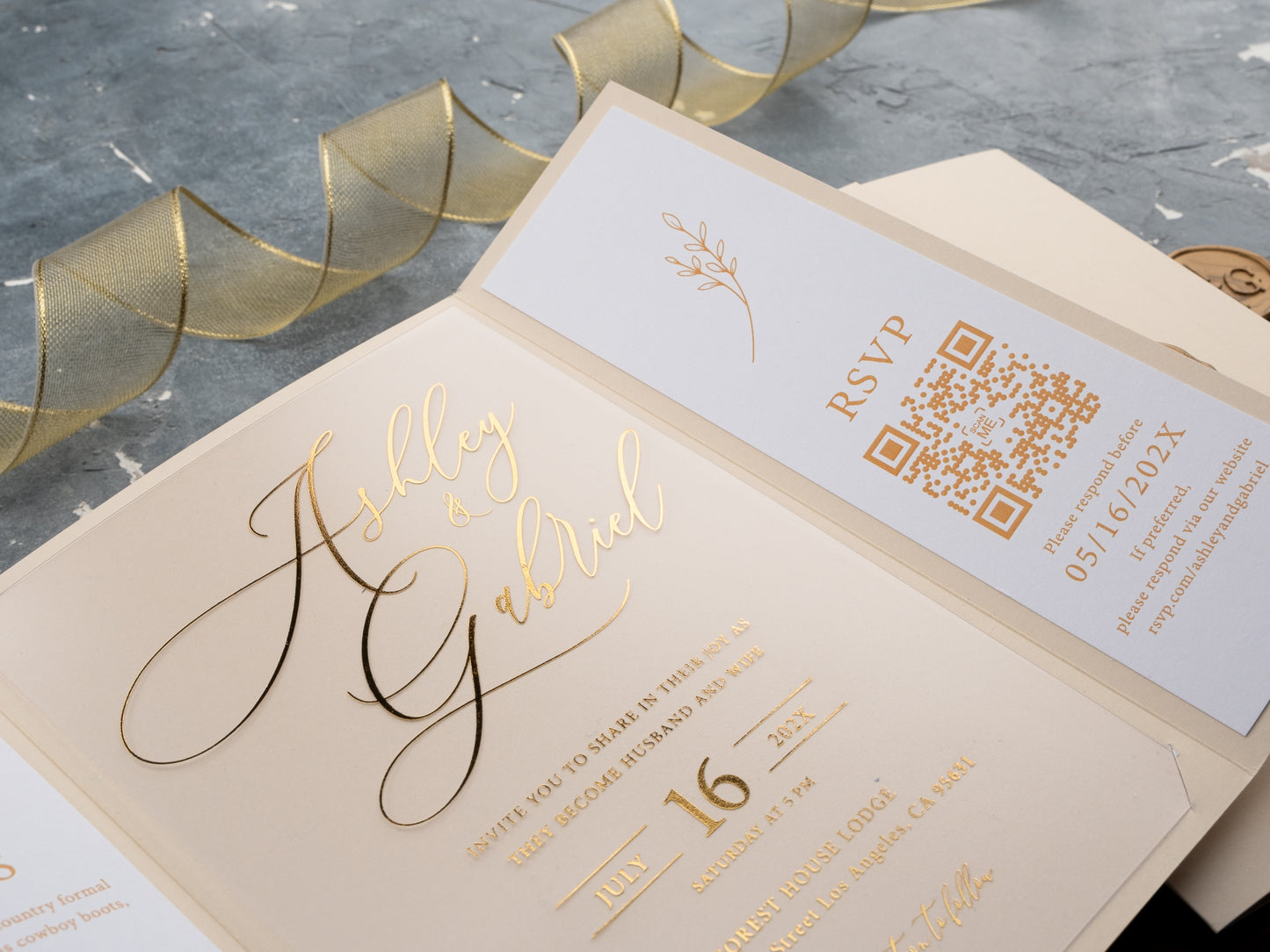 Elegant tri-fold cream invitation wrap with acrylic insert and gold calligraphy