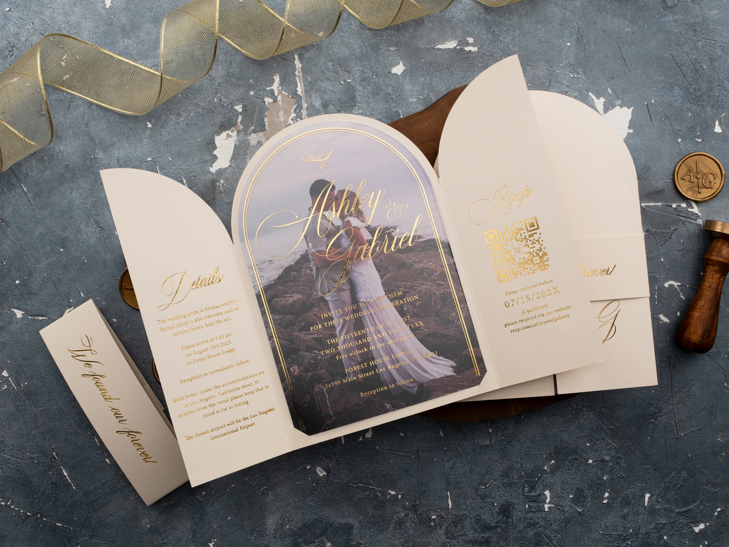 Closed ivory wedding invite with foil-stamped initials