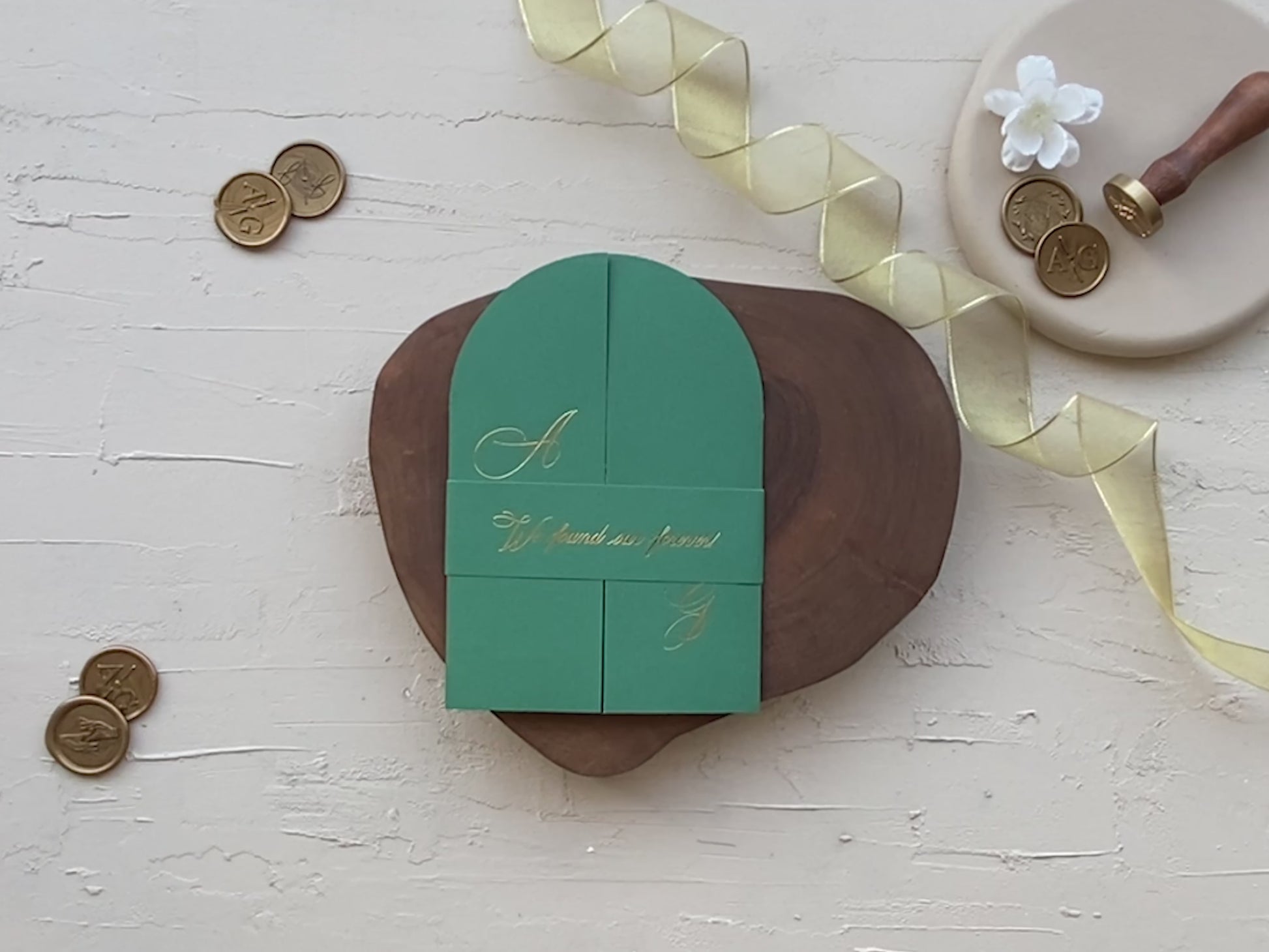 Gold foil on clear acrylic wedding invitation and emerald green folded cover