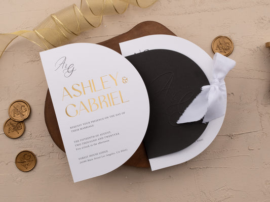 Black and gold wedding invitation with modern arch design, gold foil print, QR code RSVP, and white ribbon on neutral background